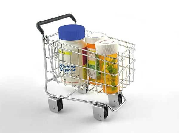 Pill bottles in a miniature shopping cart Medication Synchronization
